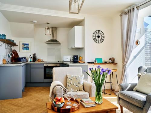 a kitchen and a living room with a table at Finest Retreats - Riverview in Stratton