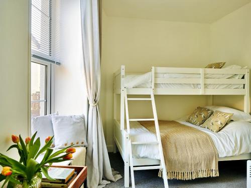 a bedroom with a white bunk bed and a window at Finest Retreats - Riverview in Stratton