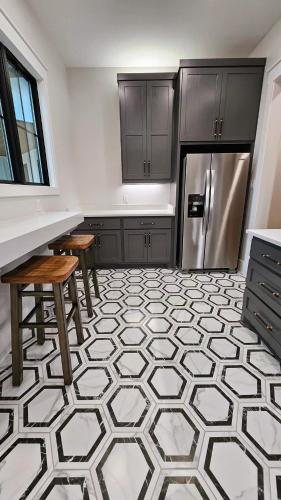 a kitchen with a refrigerator and a table and stool at Roxell Ranch-A Country Retreat 12 Guests 6 beds in Brenham