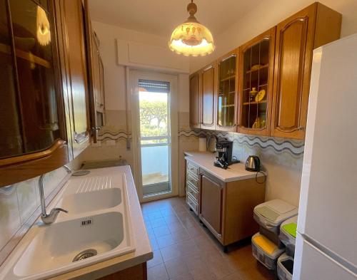 a kitchen with a large sink and a window at FELYX APARTMENT - Bright, Spacious, and 100 mt from the waves - Lavinio Mare in Anzio