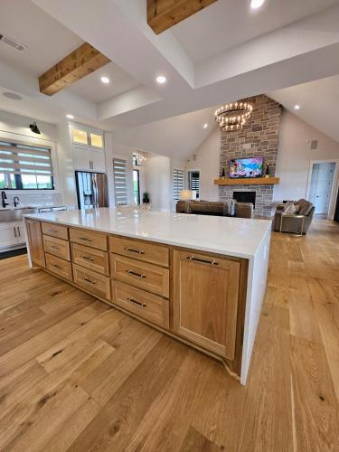 a large kitchen with a large white counter top at Roxell Ranch-A Country Retreat 12 Guests 6 beds in Brenham