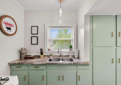 a kitchen with a sink and a window at Double the Space for Large Groups Entire Duplex in Cleveland