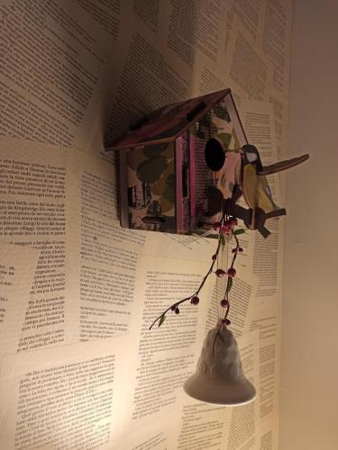 a toy bird is hanging on a book at The Lake House in Viverone