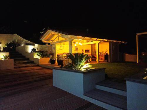 a house with a wooden deck at night at The Lake House in Viverone