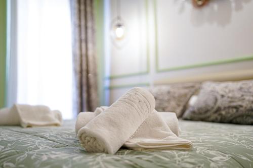 a pair of towels sitting on top of a bed at Il Cantico Suite in Assisi