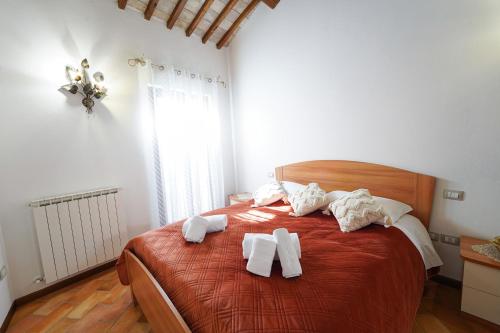 a bedroom with a bed with towels on it at Il Cantico Suite in Assisi