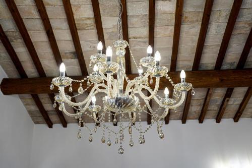 a chandelier hanging from a ceiling in a room at Il Cantico Suite in Assisi