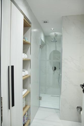 a bathroom with a shower with a glass door at Dream House Enia 4 in Shkodër
