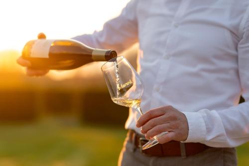 a man pouring a glass of wine at Domein Marsnil in Heers