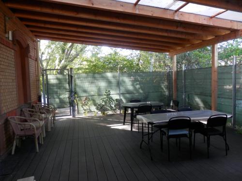 a patio with tables and chairs on a deck at Relax Hotel-Ludwigshafen in Ludwigshafen am Rhein