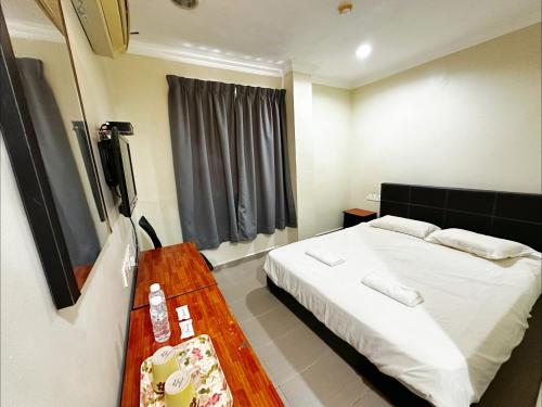 Postel nebo postele na pokoji v ubytování OYO 91150 Hotel Tasik Utama