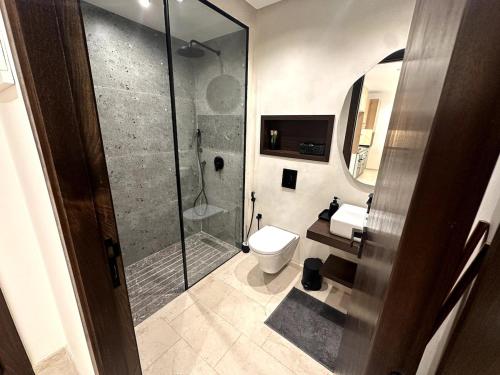 a bathroom with a shower and a toilet and a sink at Comfortable & Central Casablanca Apartment in Casablanca