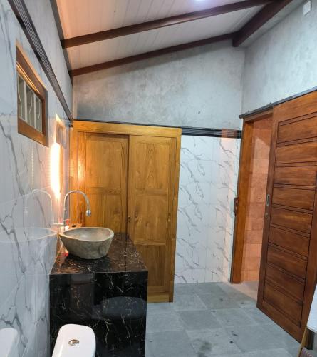 a bathroom with a sink and a bowl on a counter at Ganayu Bali Villa in Munduk