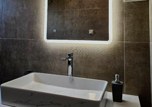 a white sink in a bathroom with a mirror at Vila OASIS - Zadar, Vrsi in Vrsi