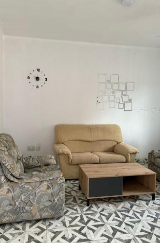 a living room with a couch and a coffee table at Seven Apartments in Serekunda
