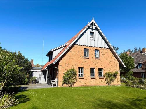 a large brick house with a gambrel roof at Auszeit in Oldsum