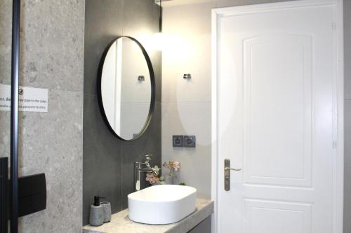 a bathroom with a sink and a mirror at Fissas Rooms in Sivota