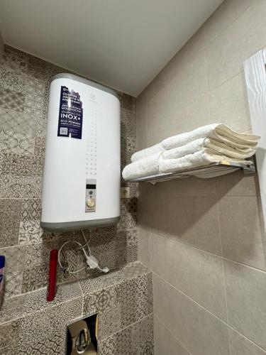 a shower in a bathroom with a sink and towels at Bamboo Beach Tsikhisdziri in Tsikhisdziri