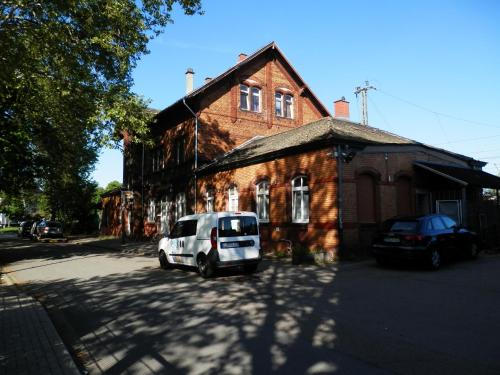 a white car parked in front of a brick building at Relax Hotel-Ludwigshafen in Ludwigshafen am Rhein
