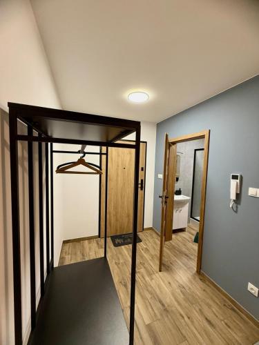 a room with a hallway with a door and a room with at LOFT APARTAMENT I Kępno in Kępno