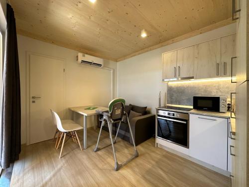 a small kitchen with a table and chairs and a stove at Villa Benisa beach in Drage