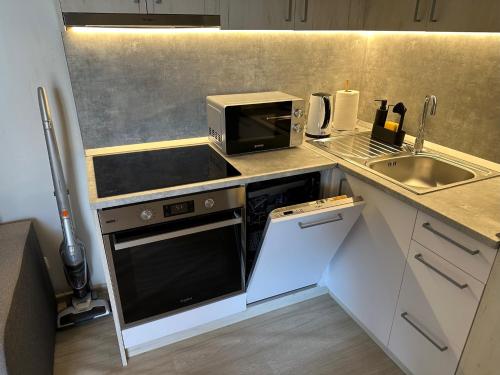 a small kitchen with a microwave and a sink at Villa Benisa beach in Drage