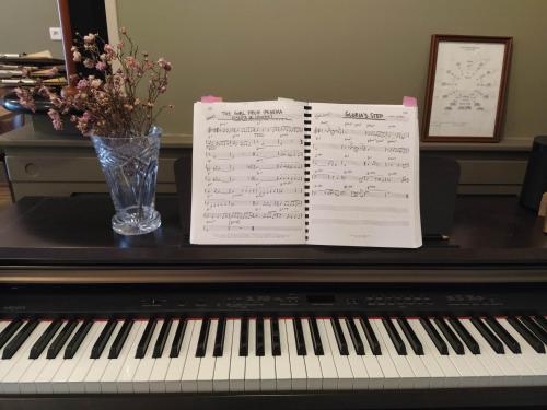 a piano with sheets of music on top of it at Hôtel restaurant Notre Dame in Orcival