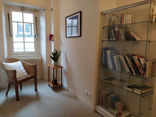 a room with a book shelf filled with books at Hôtel restaurant Notre Dame in Orcival
