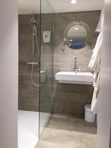 a bathroom with a sink and a glass shower at Stella Maris in Hyères