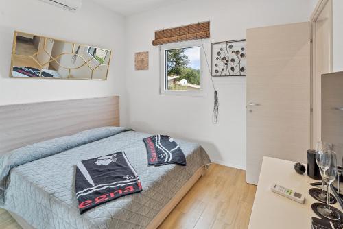a bedroom with a bed and a table at Villa Matteo Suite in Porto Columbu - Perdʼe Sali