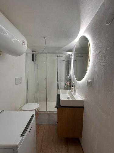 a bathroom with a toilet and a sink and a shower at Casa Frida in Capraia
