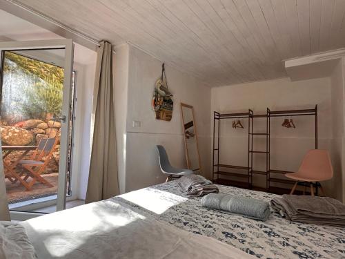 a bedroom with a bed and a sliding glass door at Casa Frida in Capraia
