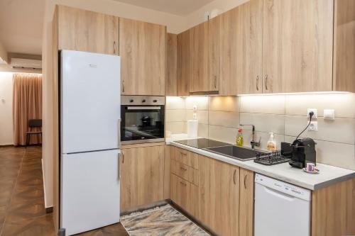 a kitchen with a white refrigerator and a sink at Ioannina Central Apartment by SuperhostHub in Ioannina