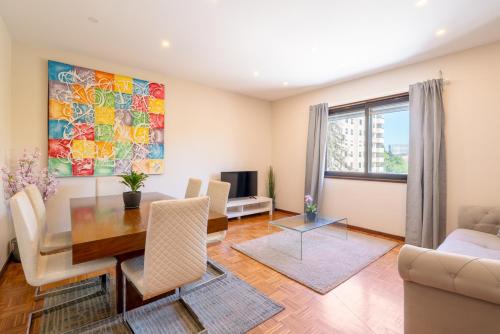 a living room with a dining table and a couch at Bright & Spacious Flat by Host Wise in Porto