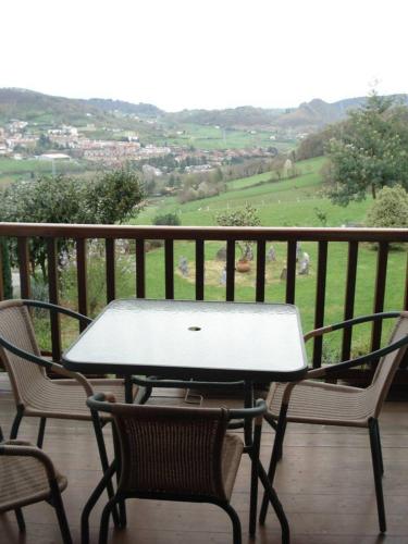 a table and two chairs on a balcony with a view at Casa Rural Olazi in Oiartzun