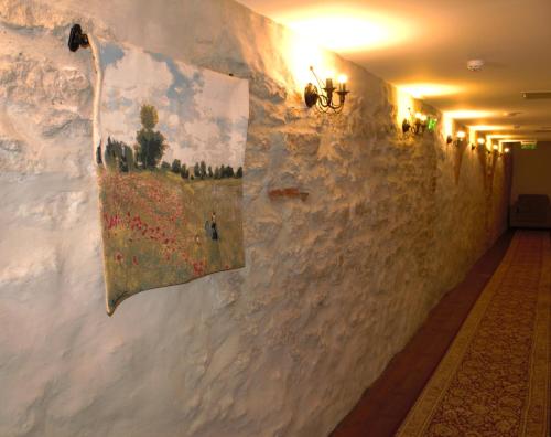 a hallway with a wall with paintings on it at Taanilinna Hotell in Tallinn
