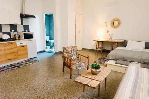 a bedroom with a bed and a chair and a table at The SPiTi Project 33 in Kavala
