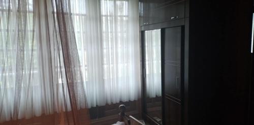 a window with white curtains in a room at Special Guest House in Guria in Chala