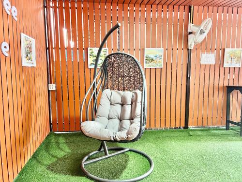 a chair sitting in a room in a building at Jamjuree Place in Ban Si Than