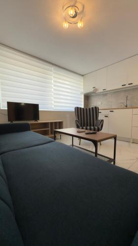a bedroom with a bed and a table and a chair at Dad's Studio in Kavala