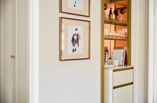 a hallway with two framed pictures on a wall at Four Seasons Hotel Milano in Milan