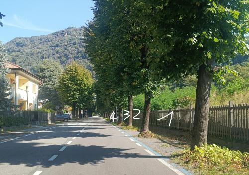 a road with trees on the side of the road at Casa Bianca, Vista unica sul lago di Como in Dervio