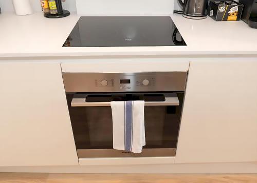 a kitchen with an oven with a towel hanging from it at Bright 3 Bed 2 Bath with Air Con in Clerkenwell - Pass the Keys in London