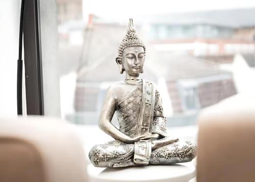 a statue of a buddha sitting in a window at Bright 3 Bed 2 Bath with Air Con in Clerkenwell - Pass the Keys in London