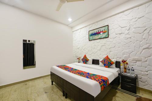a bedroom with a large bed and a wall at FabHotel Silver Stone in Noida