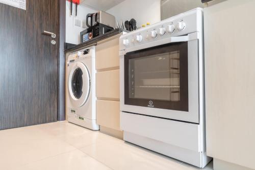 a washer and dryer in a kitchen with a washing machine at Beautifully Furnished Studio with Skyline Views in Dubai Marina
