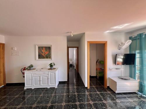 a room with a white cabinet and a tv at Ático San Juan Teide View in Playa de San Juan