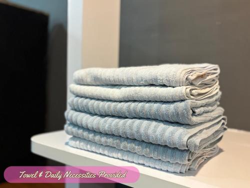 a stack of towels sitting on a table at The Traveler's Retreat, Melaka Raya, Malacca, Walk 10min to A'Famosa in Melaka