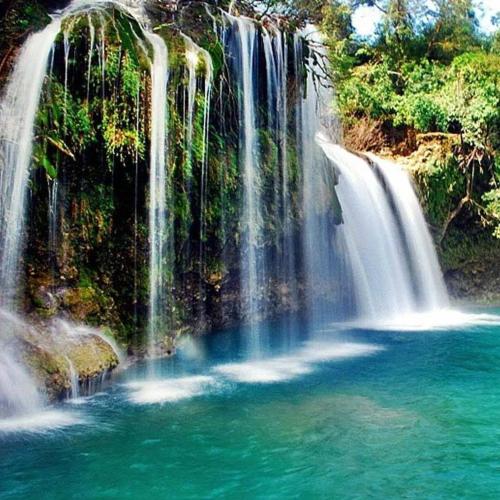 a group of waterfalls falling into a pool of water at Aiko Beach Isla Sunrise Resort in Bolinao