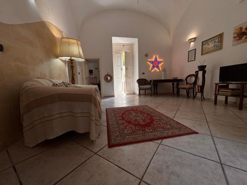 a bedroom with a bed and a living room with a table at Mary Apt - Historical Residence- Lecce in Lecce